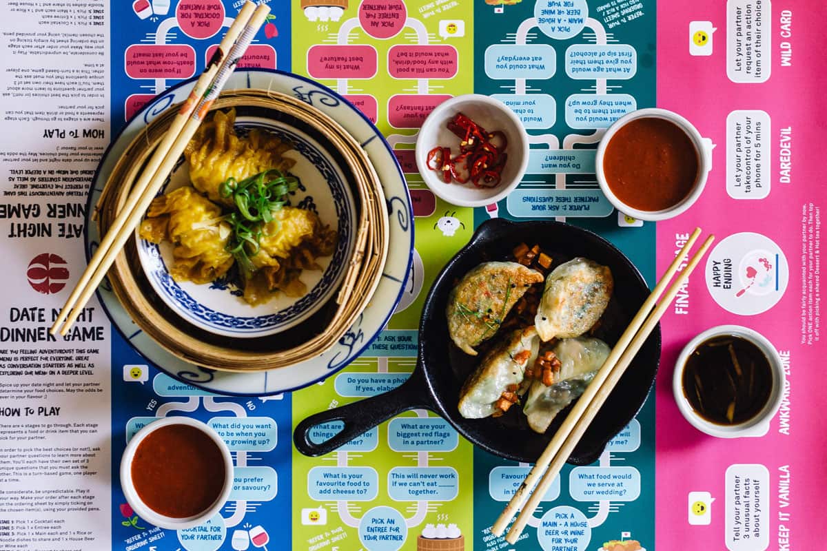Yum cha plates arrive on a board game offering couples getting-to-know-you questions.