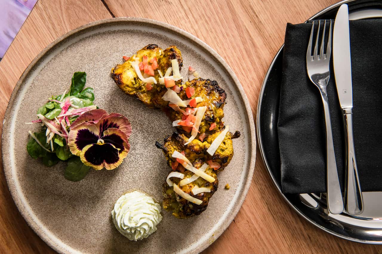 The tandoori chicken is served with jicama, yoghurt emulsion and watercress salad.