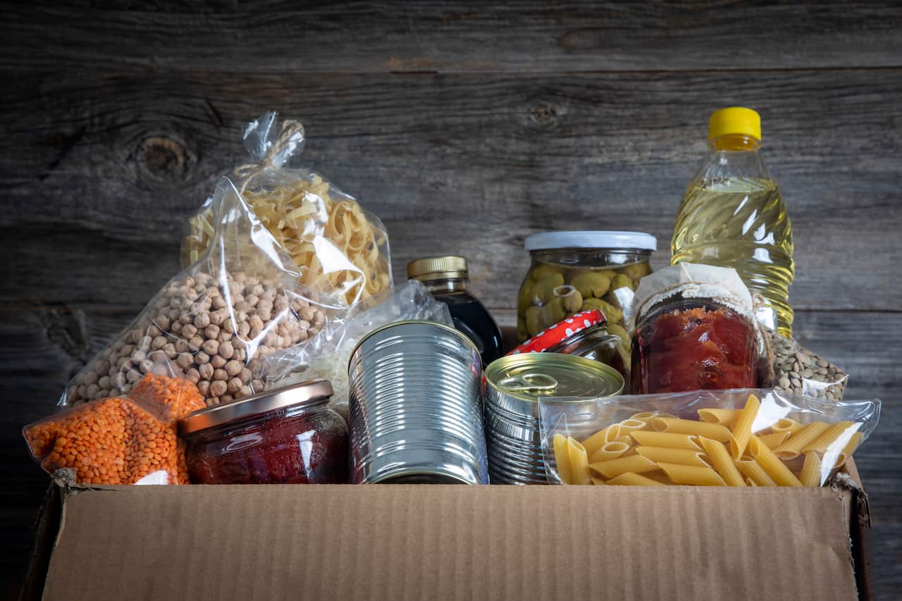 Volunteer with box of food for poor 