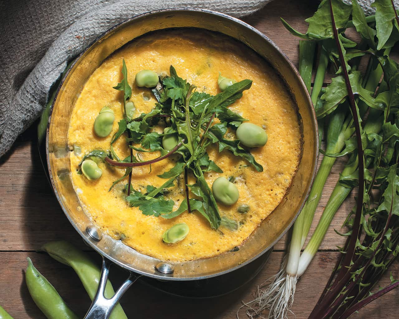 Fresh broad beans with eggs and cheese