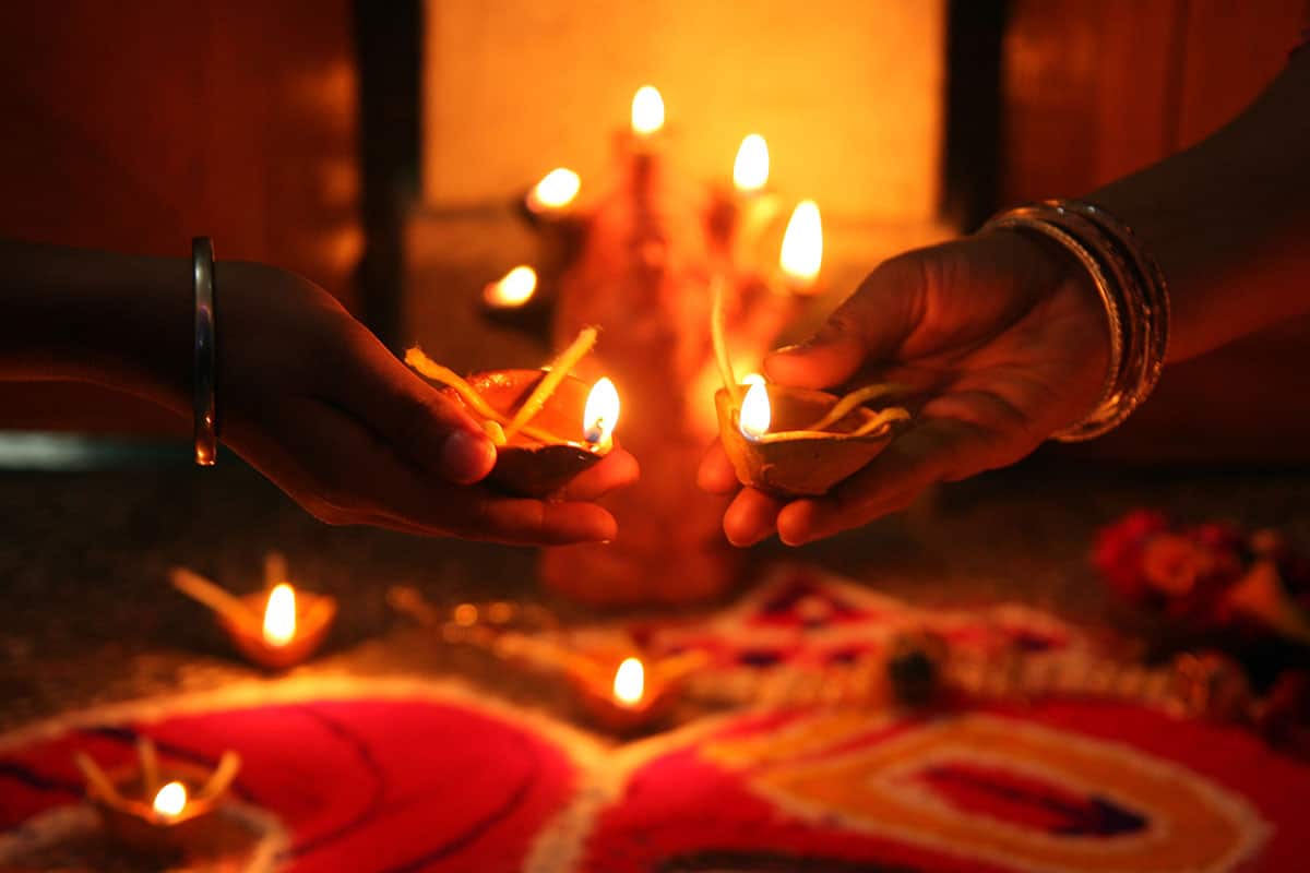 Lighting oil lamps for Diwali in Allahabad on November 13, 2012