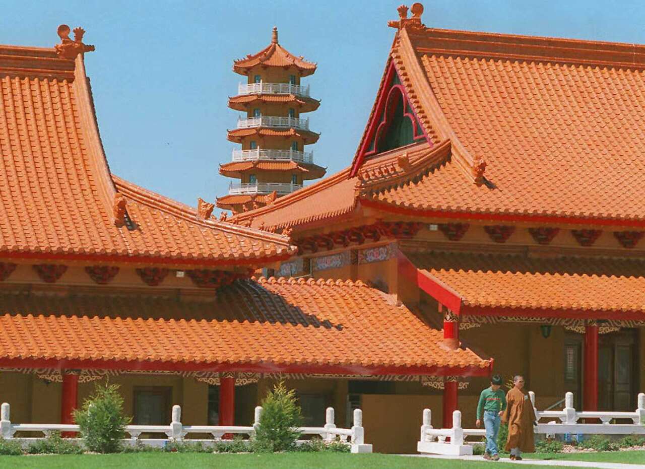 Reverend Man Chien (R) leads a volunteer worker (L