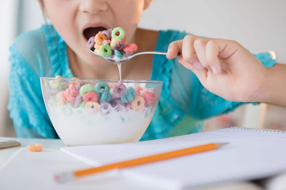 Girl eating sugary cereal 
