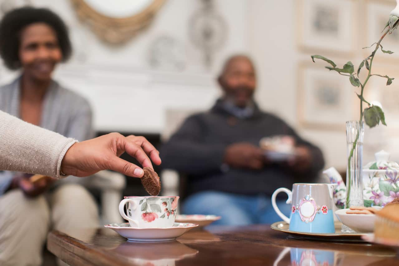 Hand dipping cookie in tea, Cape Town, South Africa