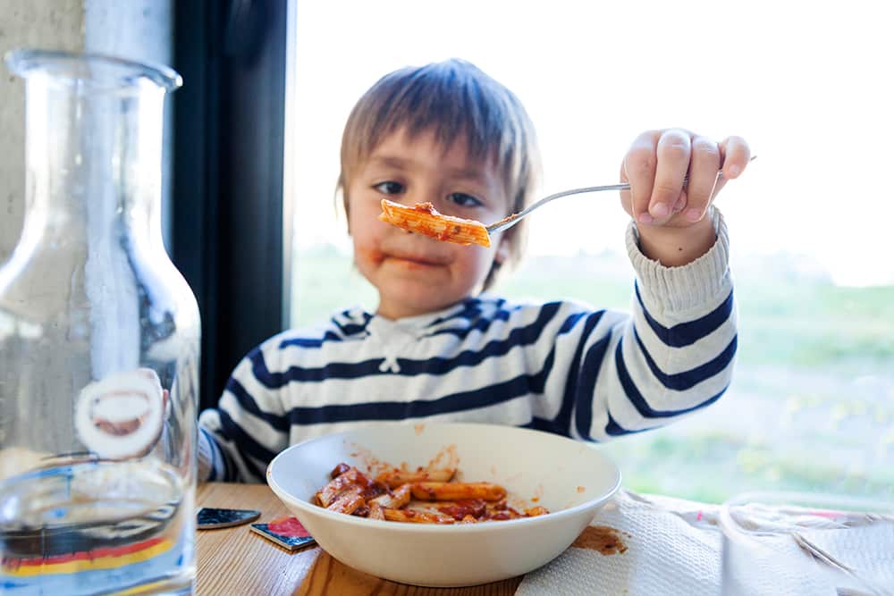 Child eating pasta