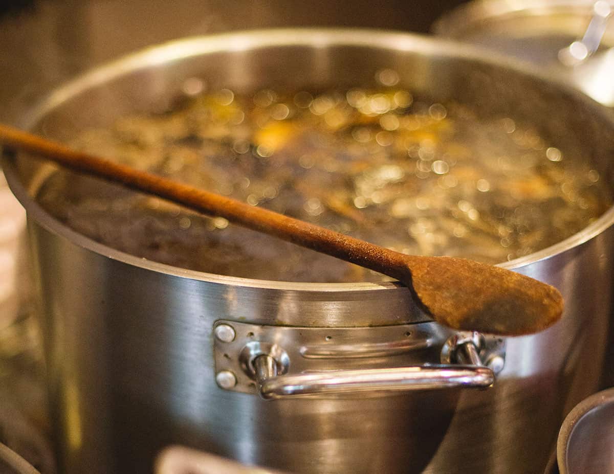 Pot of boiling water with a wooden spoon.