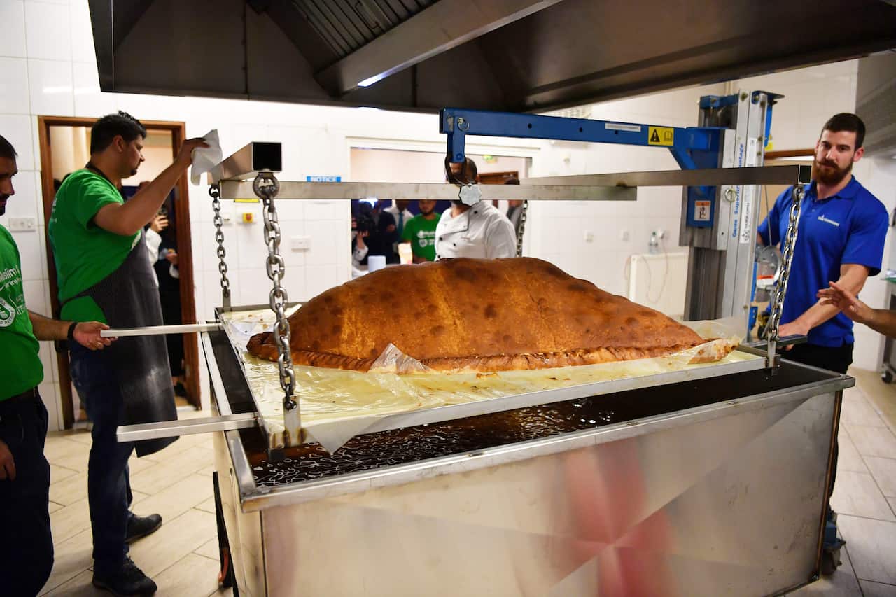 Muslim Aid staff work as they attempt to cook the world's largest samosa at the East London Mosque in London on August 22, 2017.