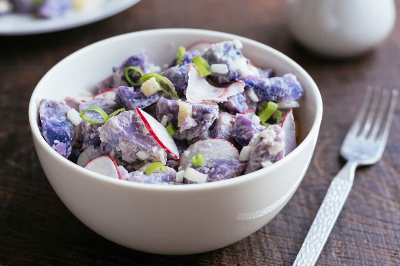 Purple potato salad with radish. 