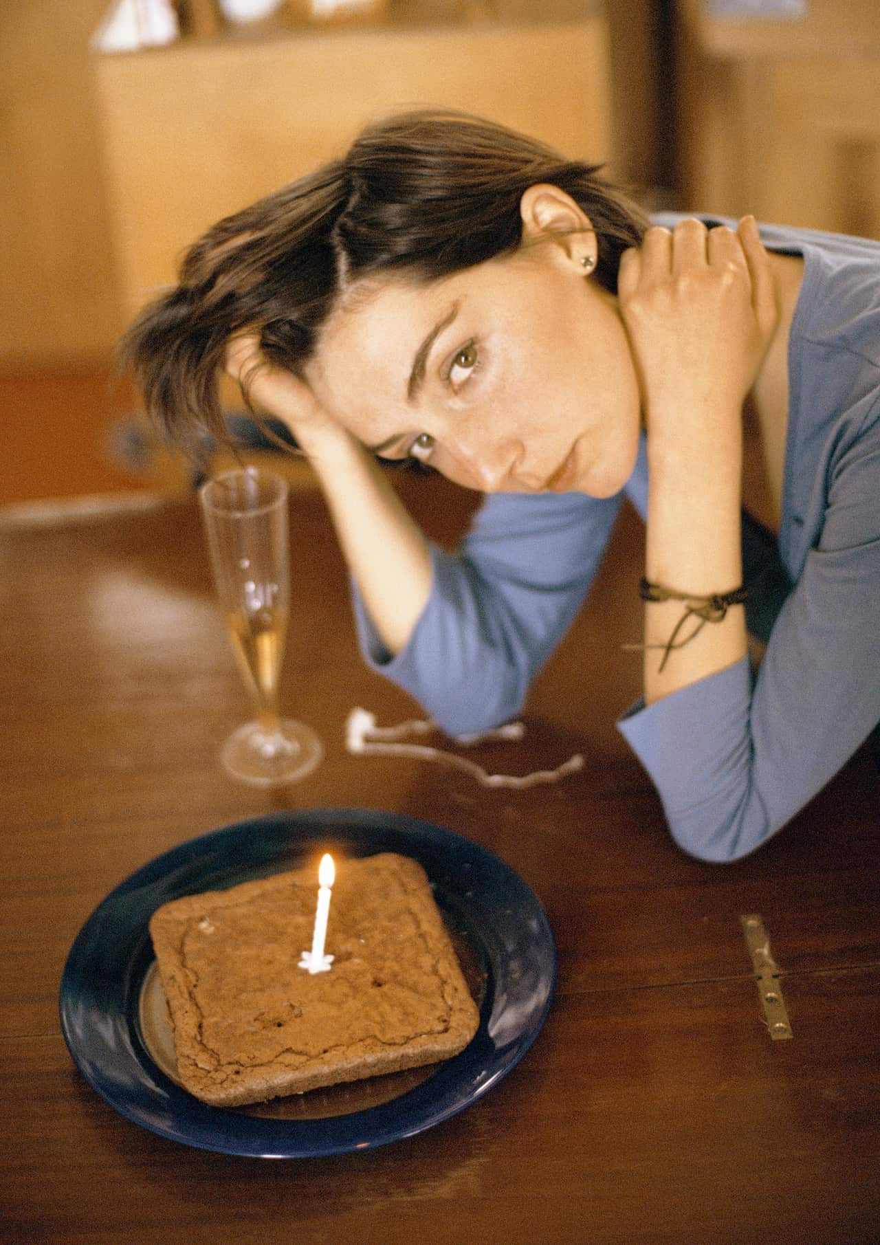 Woman at table with cake and candle, portrait