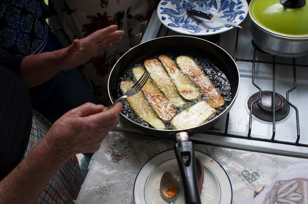 Zucchinis being fried by Tsintziras' mother for the dish, soufiko.