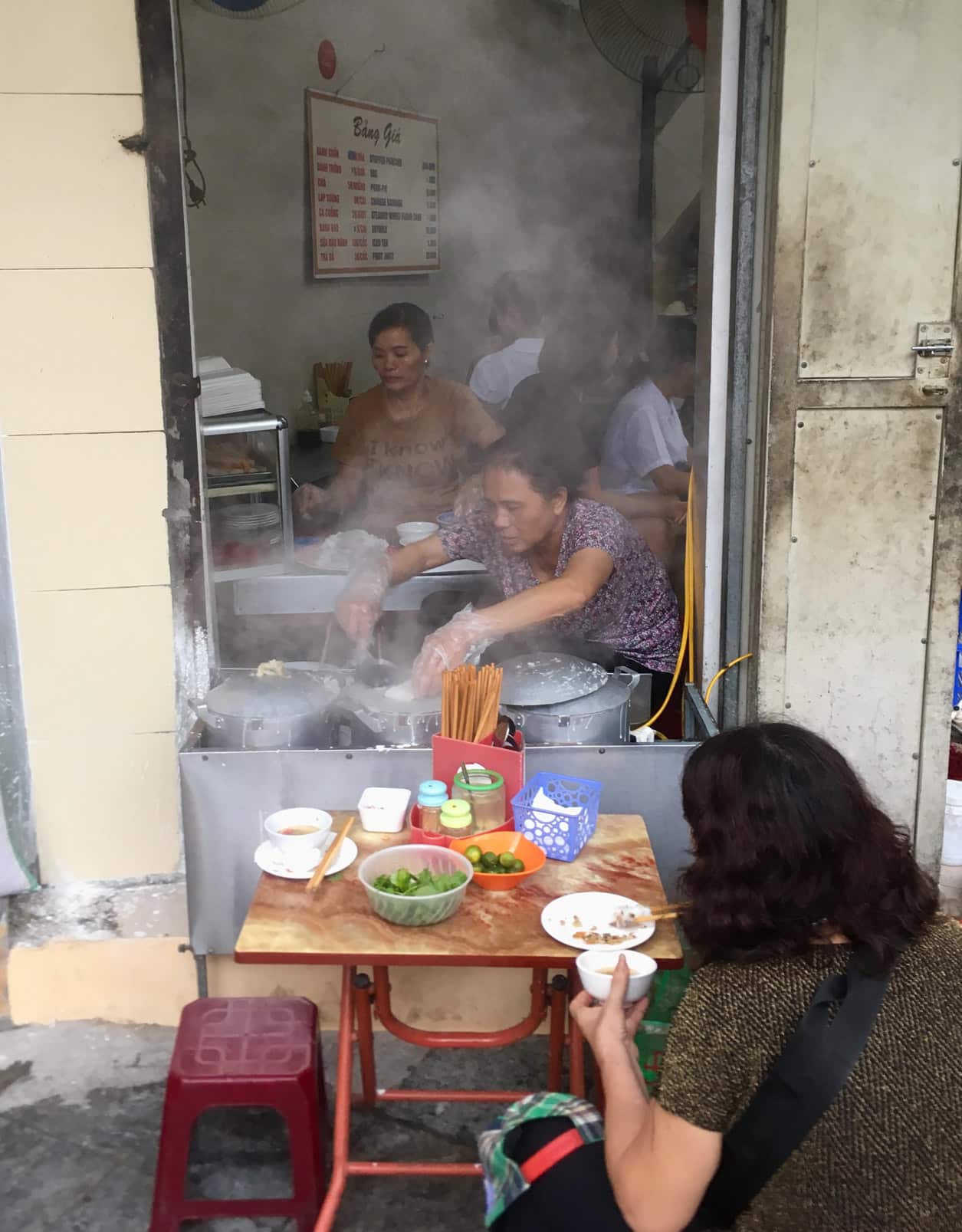 Eating street food in Hanoi.