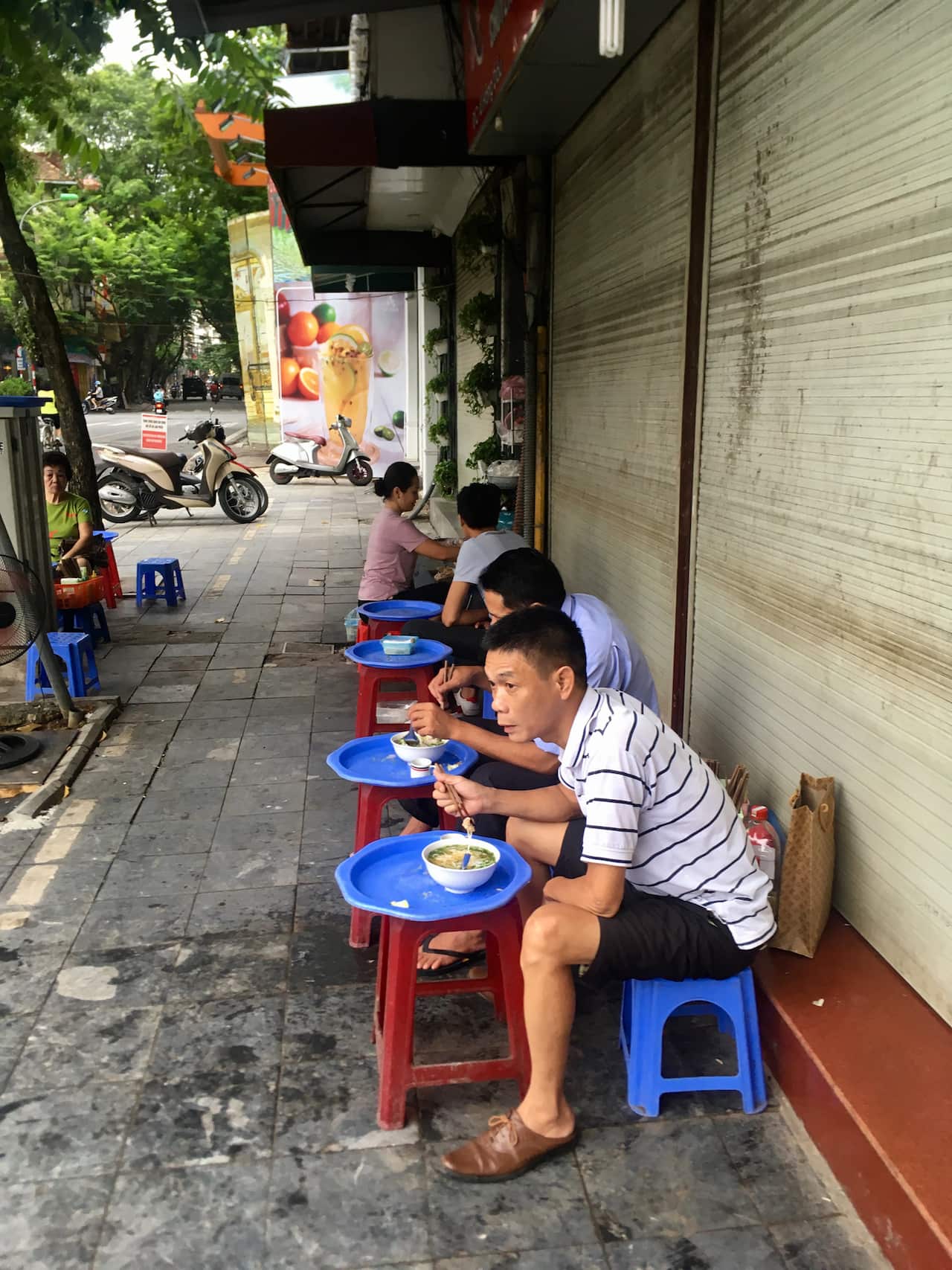 Eating street food in Hanoi.