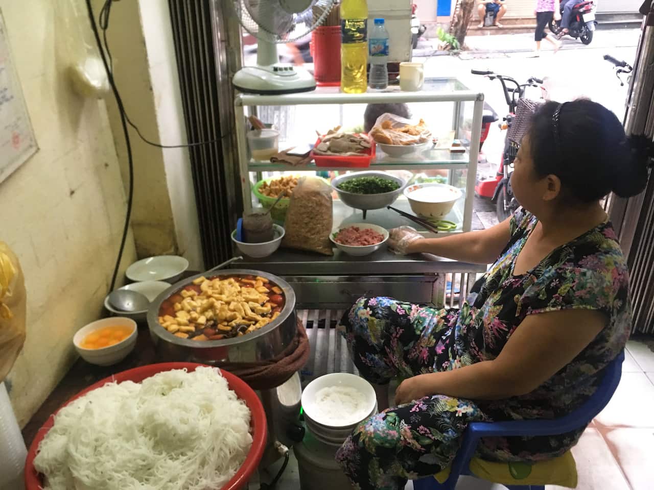 Eating street food in Hanoi.