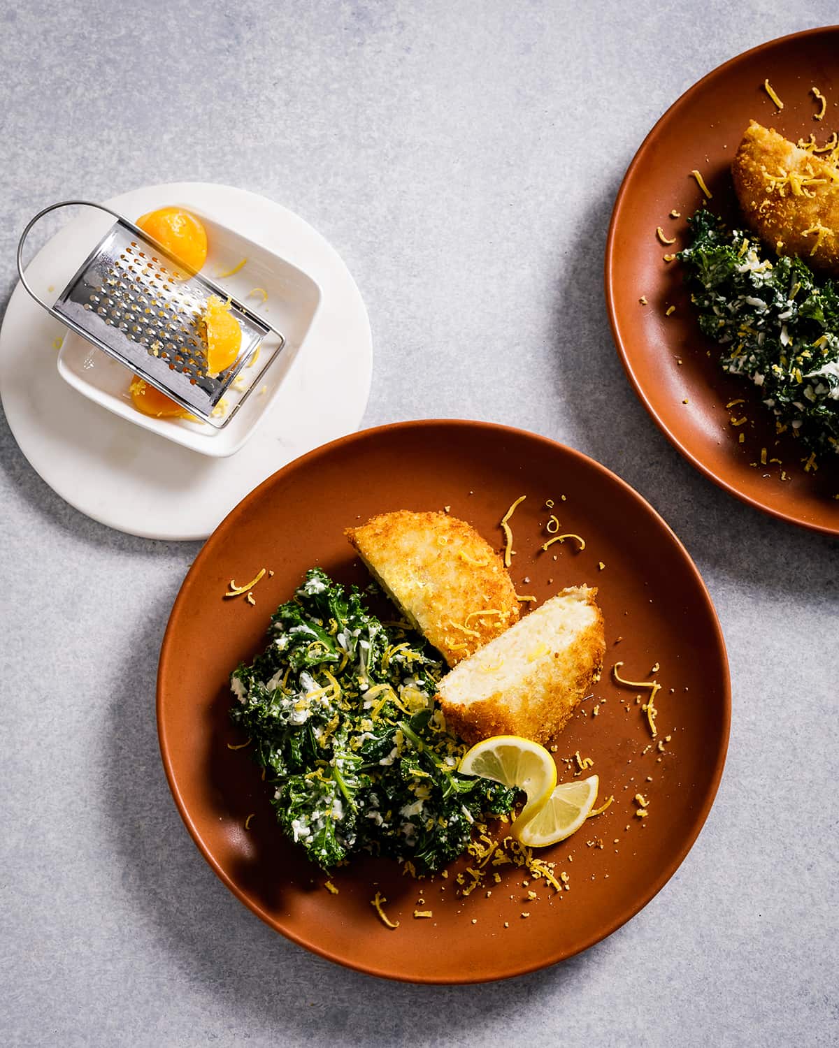 Herring cakes with kale salad and cured egg yolk