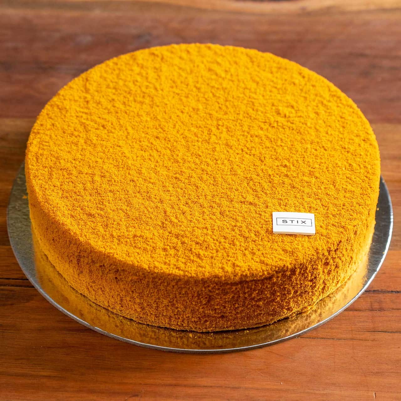 The cake is dusted in honey biscuit powder.