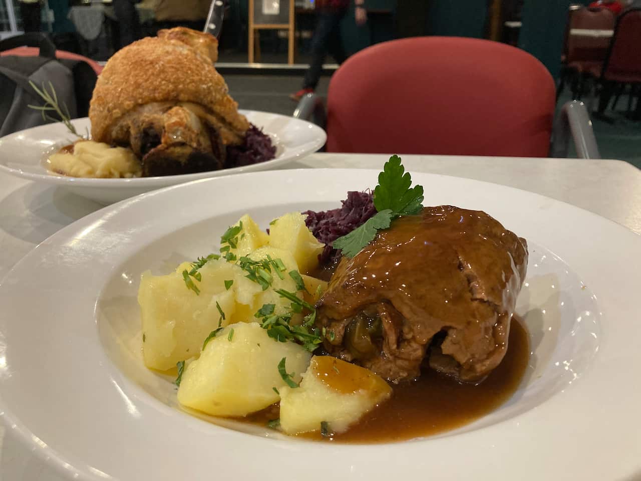 Beef roulade at the Concordia Club – rolled beef fillet stuffed with onions, speck and gherkins - served with parsley potatoes and red cabbage. 