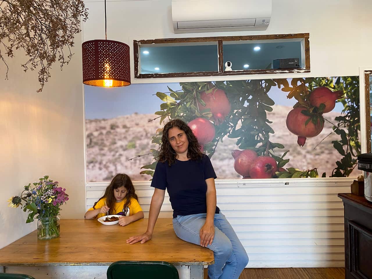 Aviva Visoli in her restaurant with one of her children.