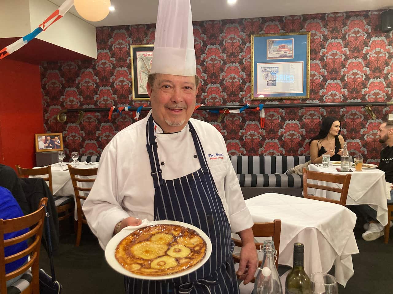 Chef Philippe Lebreux of French restaurant, Chez Pascal, with his house specialty: crêpe Normande.