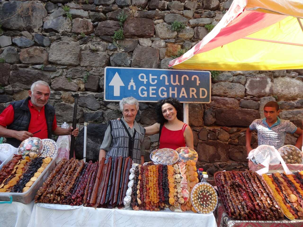 Arpy Iskikian, a caterer and cook from Sydney’s Armenian community, poses with women selling Armenian delicacies near Geghard 