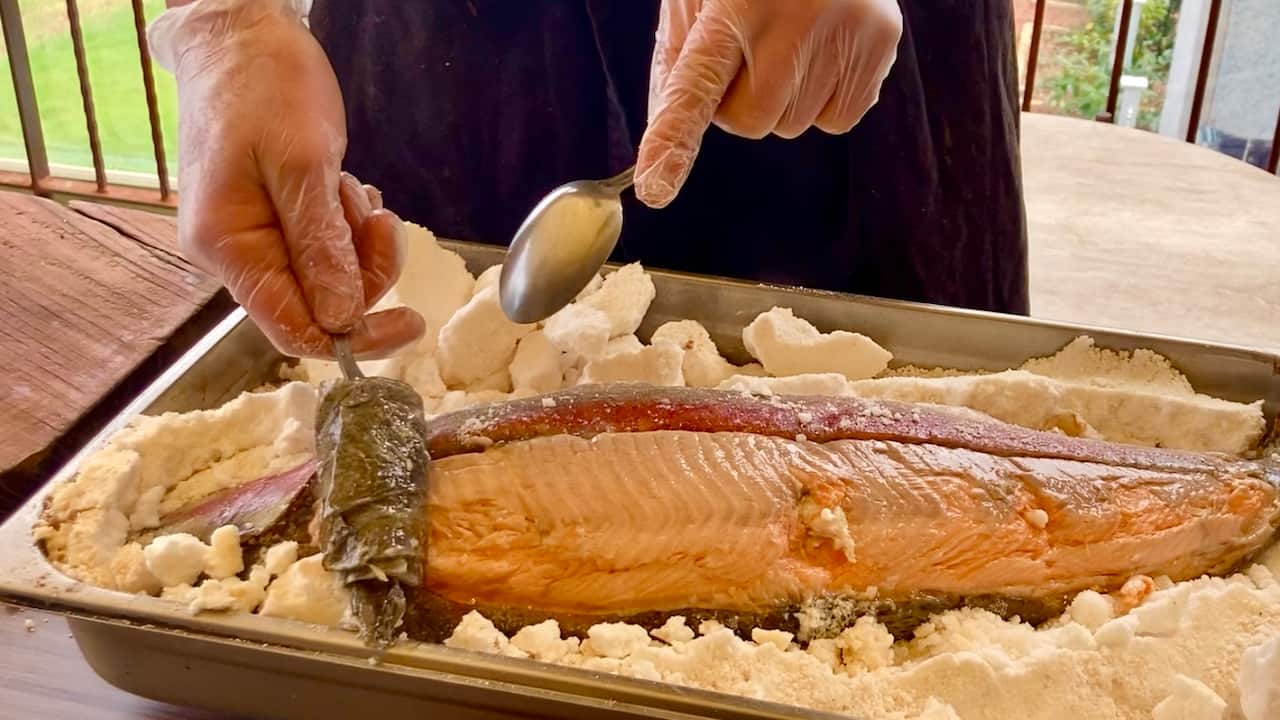 A whole ocean trout cooked in salt crust cooked in the infiernillo forms part of Farrell's asado fire feast at Osborn House.