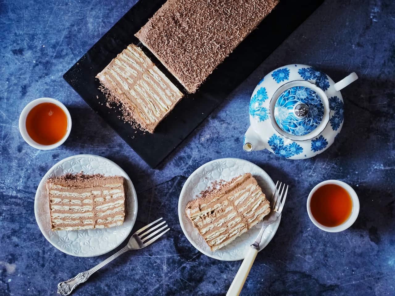 Bosnian biscuit cake served in slices, with hot tea