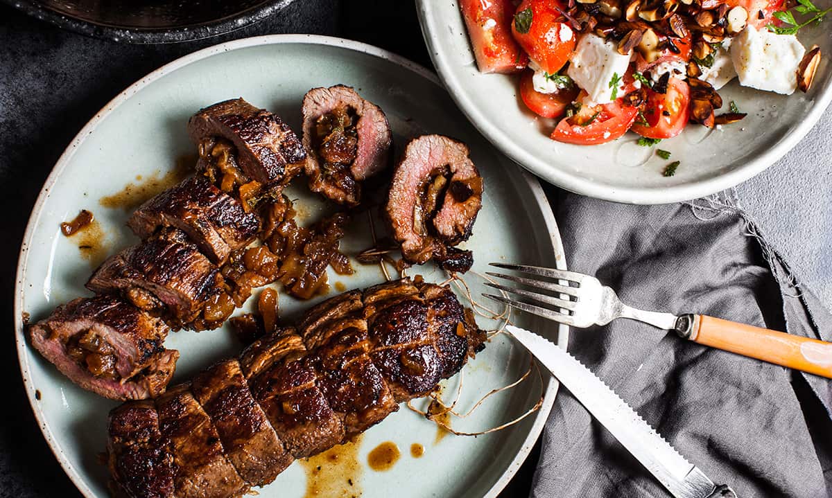 Apricot-stuffed lamb backstrap with tomato and almond salad