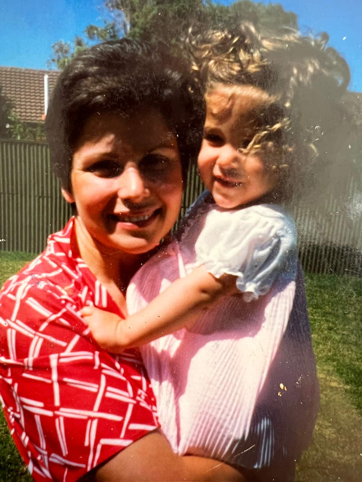 Julia Busuttil Nishimura as a child (right) with her mum.