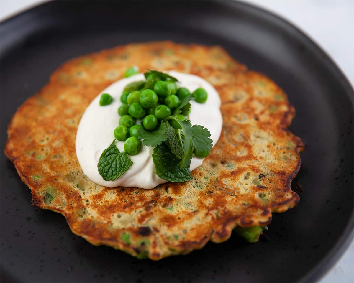 Kale and pea socca with yoghurt tahini dressing