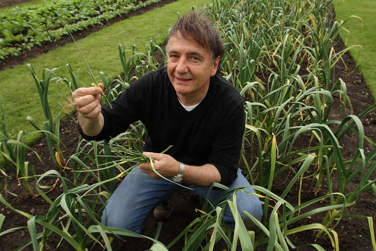 Raymond Blanc in the garlic plot at Kew Gardens.
