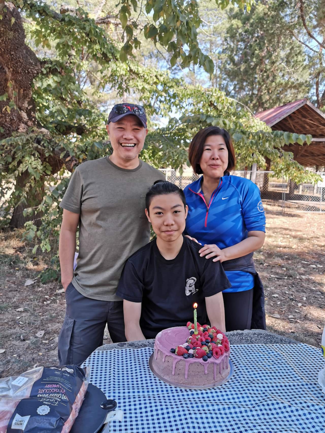 Ivan and wife Liwe with Marcus celebrating his birthday with a gluten-free cake. 