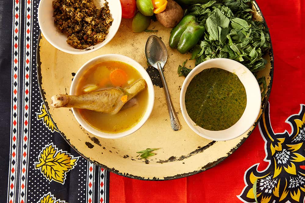 Boiled chicken in a tomato stew with potatoes, carrot and capsicum (mchemsho wa kuku)