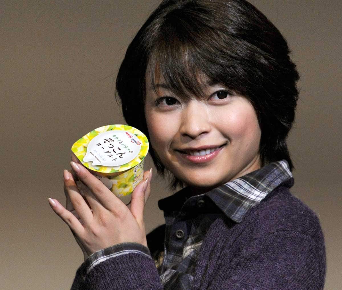 Model with tub of Meiji yoghurt in Japan 