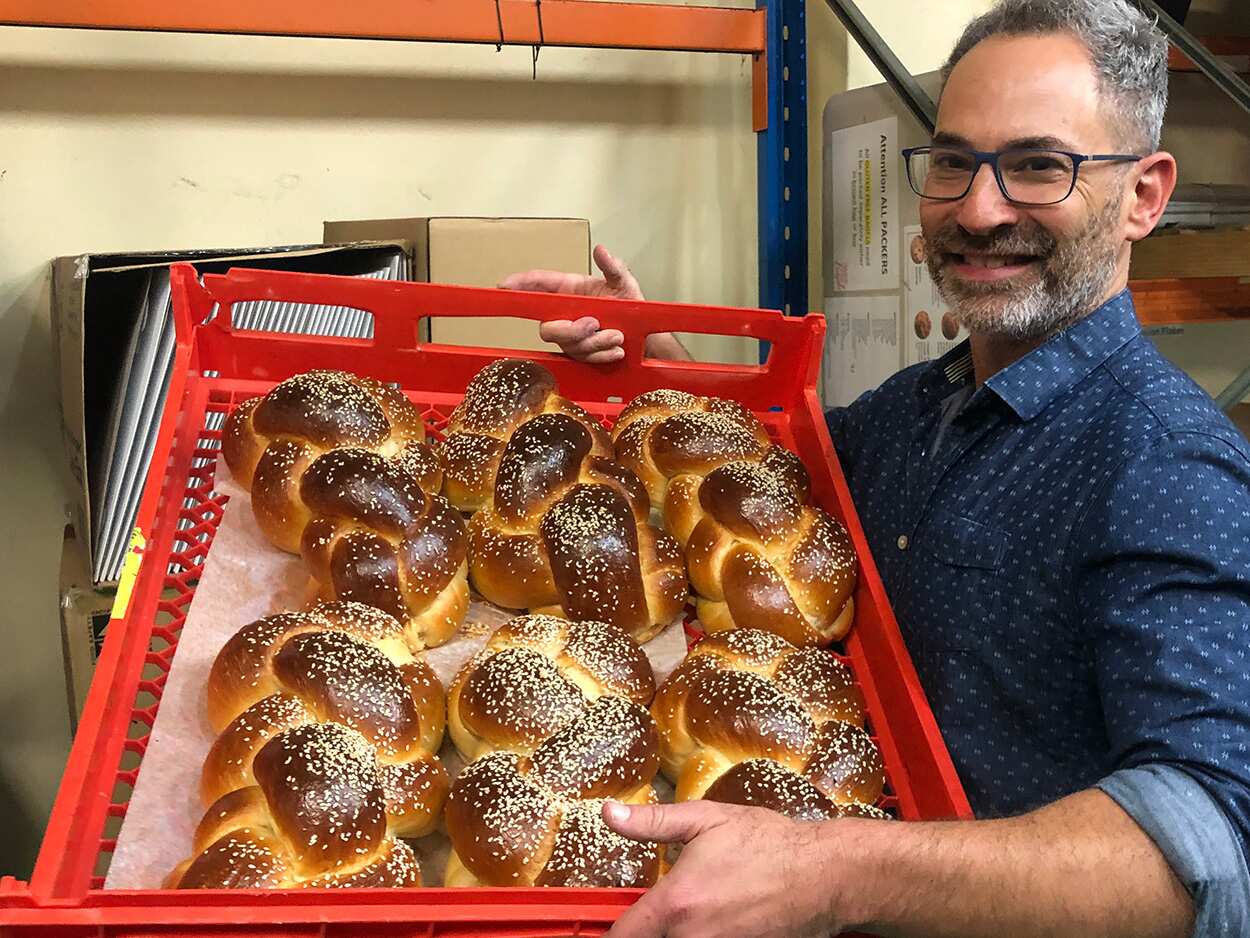 Michael Shafran with challah at Brooklyn Boy Bagels bakery