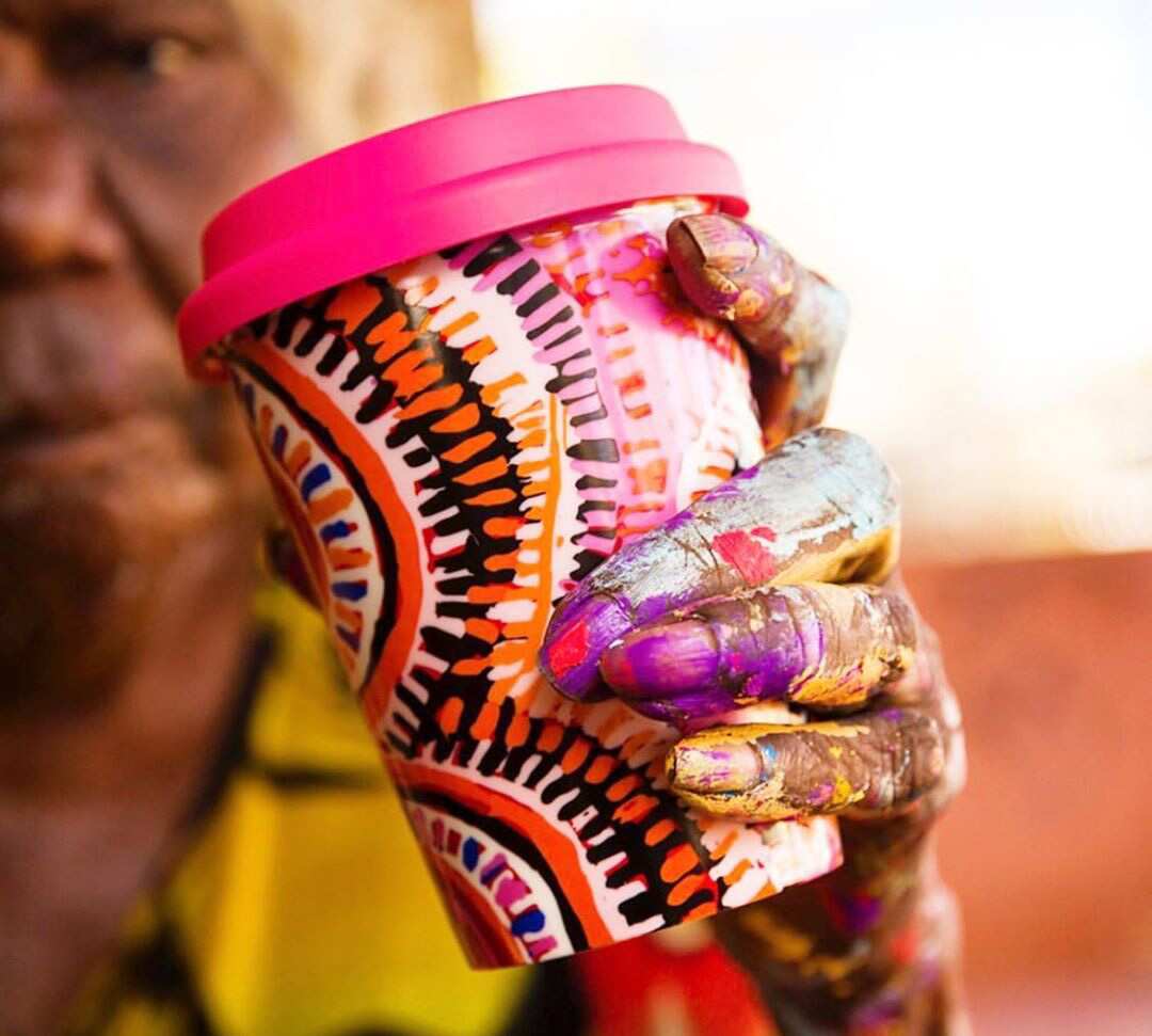  Murdie Nampijinpa Morris, posing with a porcelain keep cup featuring her design