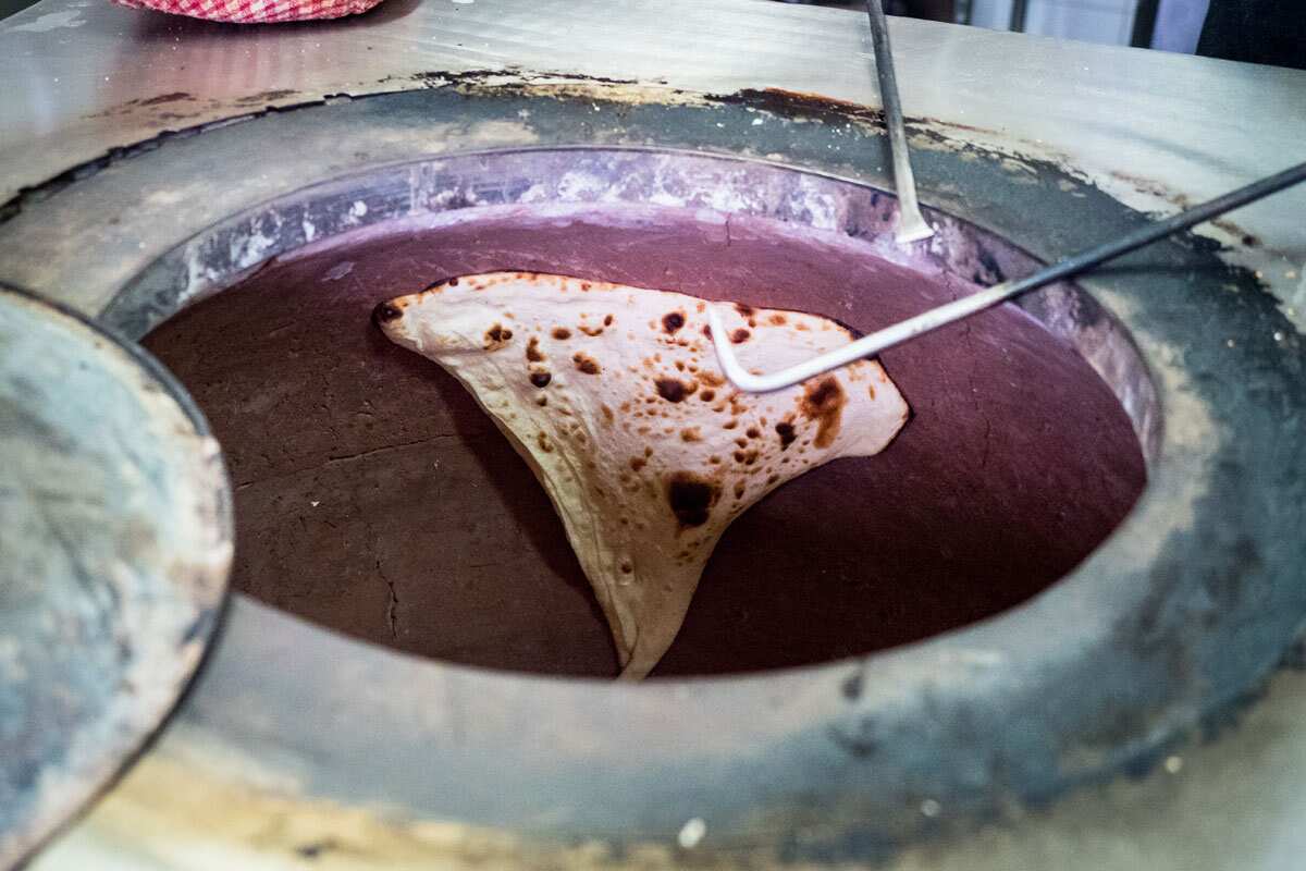 Naan bread is cooked in the tandoor at Punjabi Fusion.