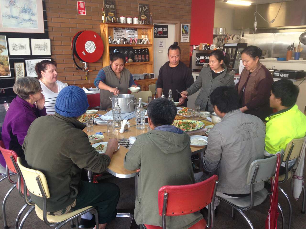 A group of Karen refugees sharing lunch in the café.
