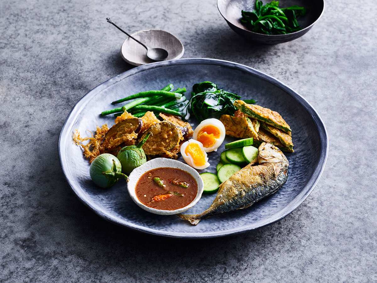 Nahm Prik Kapi is traditinally a shared plate of fried rice in a chilli relish, accompanied by accoutrements.