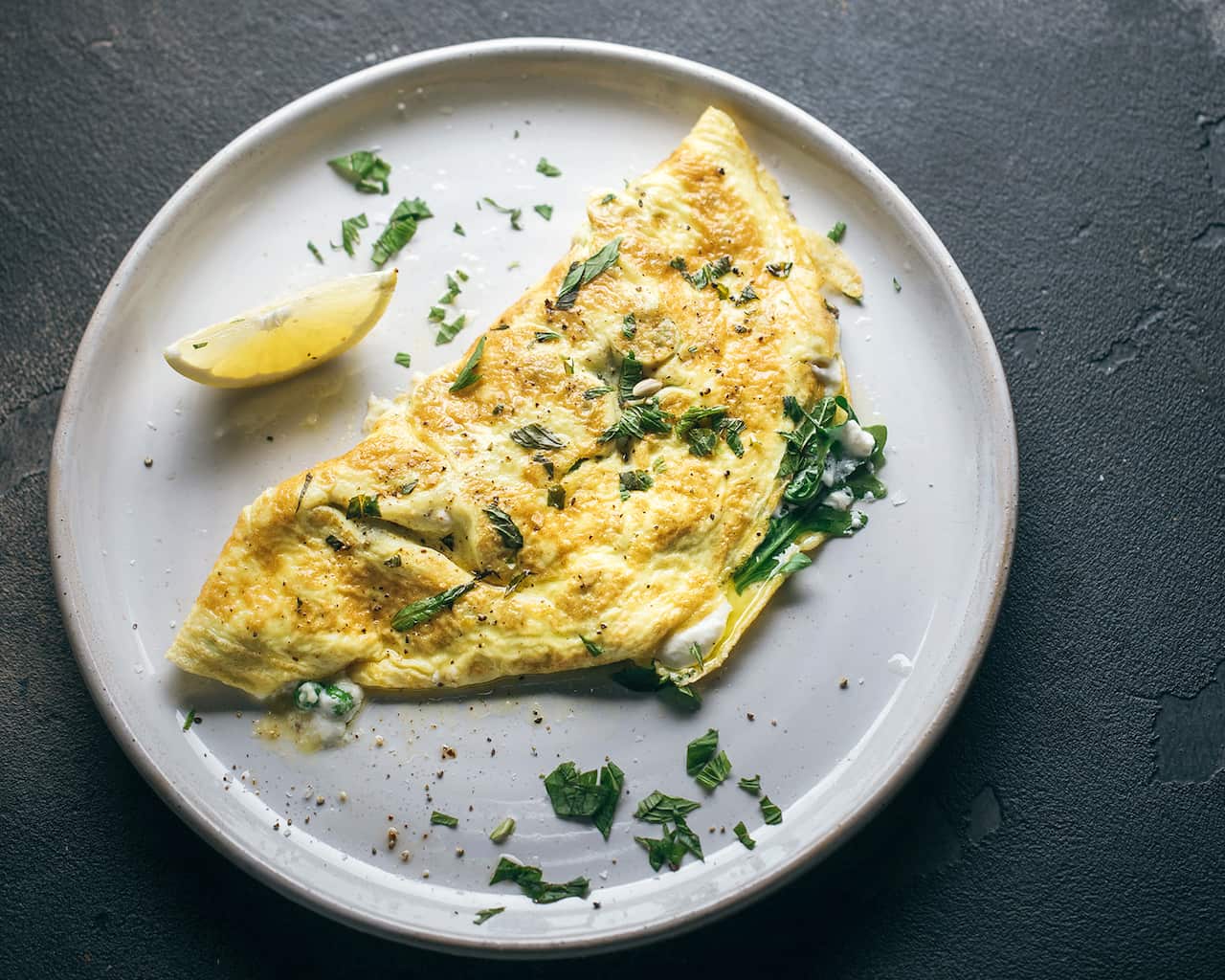 Omelette with greens, peas, ricotta and mint
