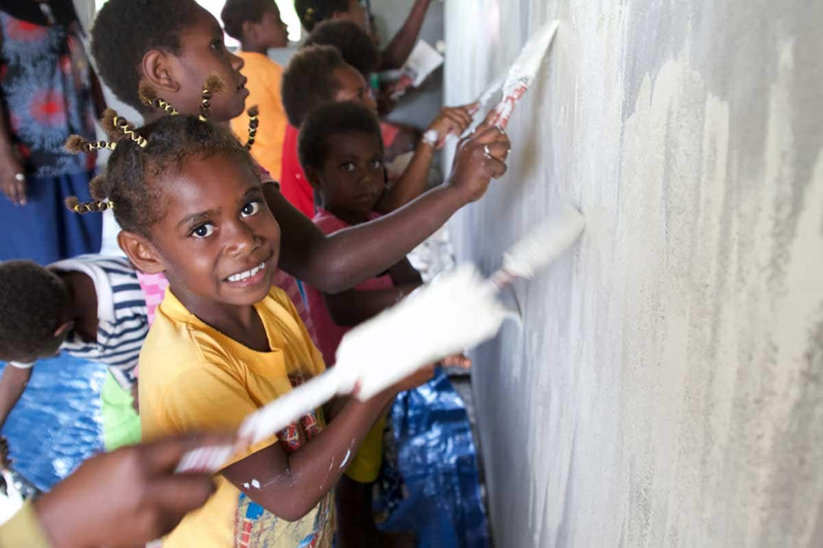 Children help with work on a Co-Ground-funded project. 