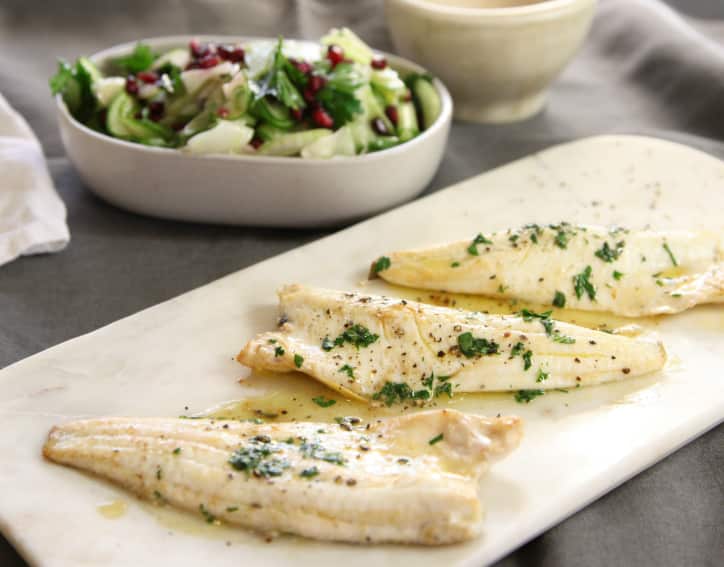 Pan-fried whiting with celery and pomegranate salad