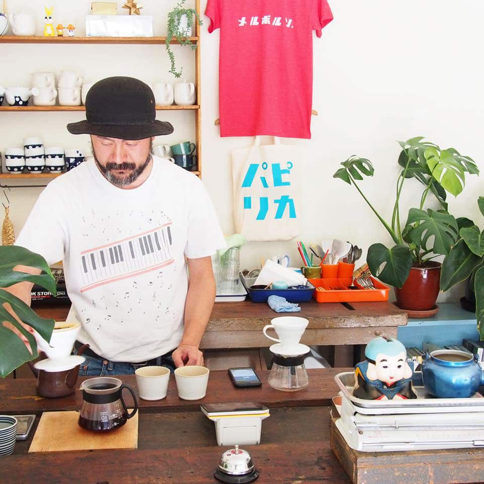 One of the cafe workers serving coffee in this Japanese-style cafe.