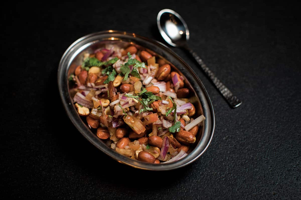 Madras Cricket Club Peanuts (MCC) peanuts are seasoned with spices, chopped onions, tomatoes, pepper and lemon juice.