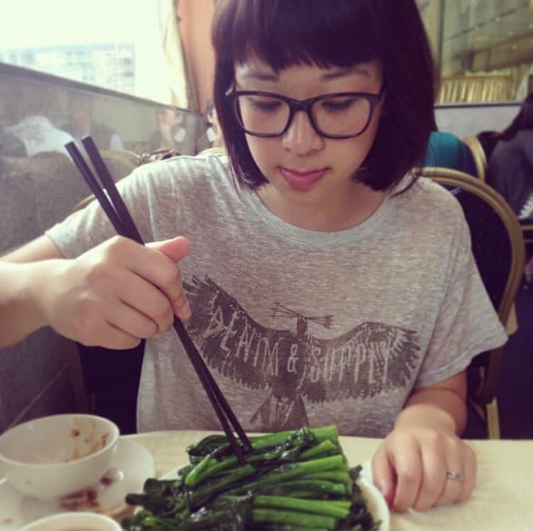 Chrissy Lau, aged around 29, eating the food of her heritage.