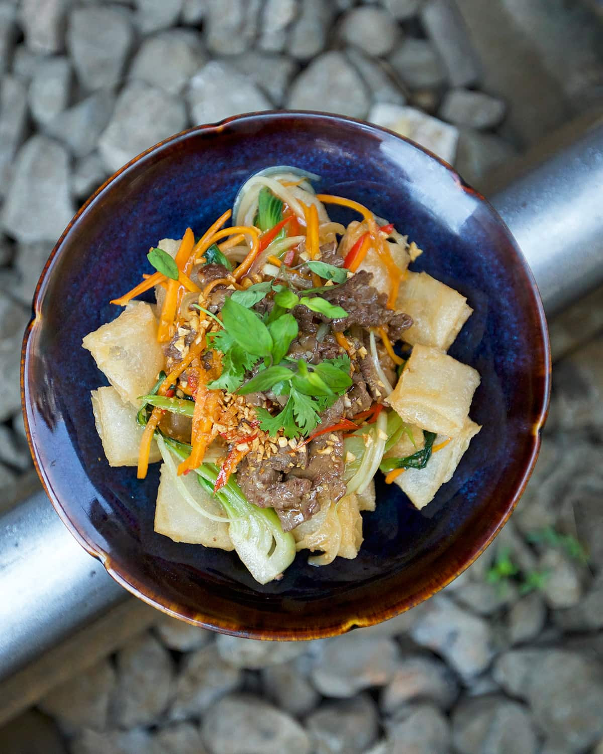 Crispy noodle pillows with stir-fried beef