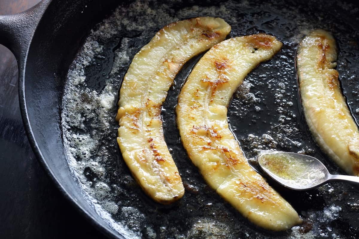 Bananas cooking in cast iron pot.