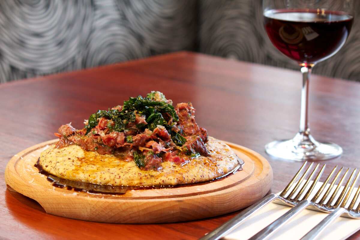 Red-flint polenta with goat ragu, cavolo nero and prosciutto  