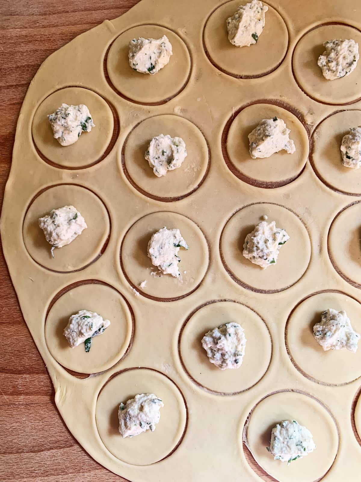 Adding the filling to the ravjul.