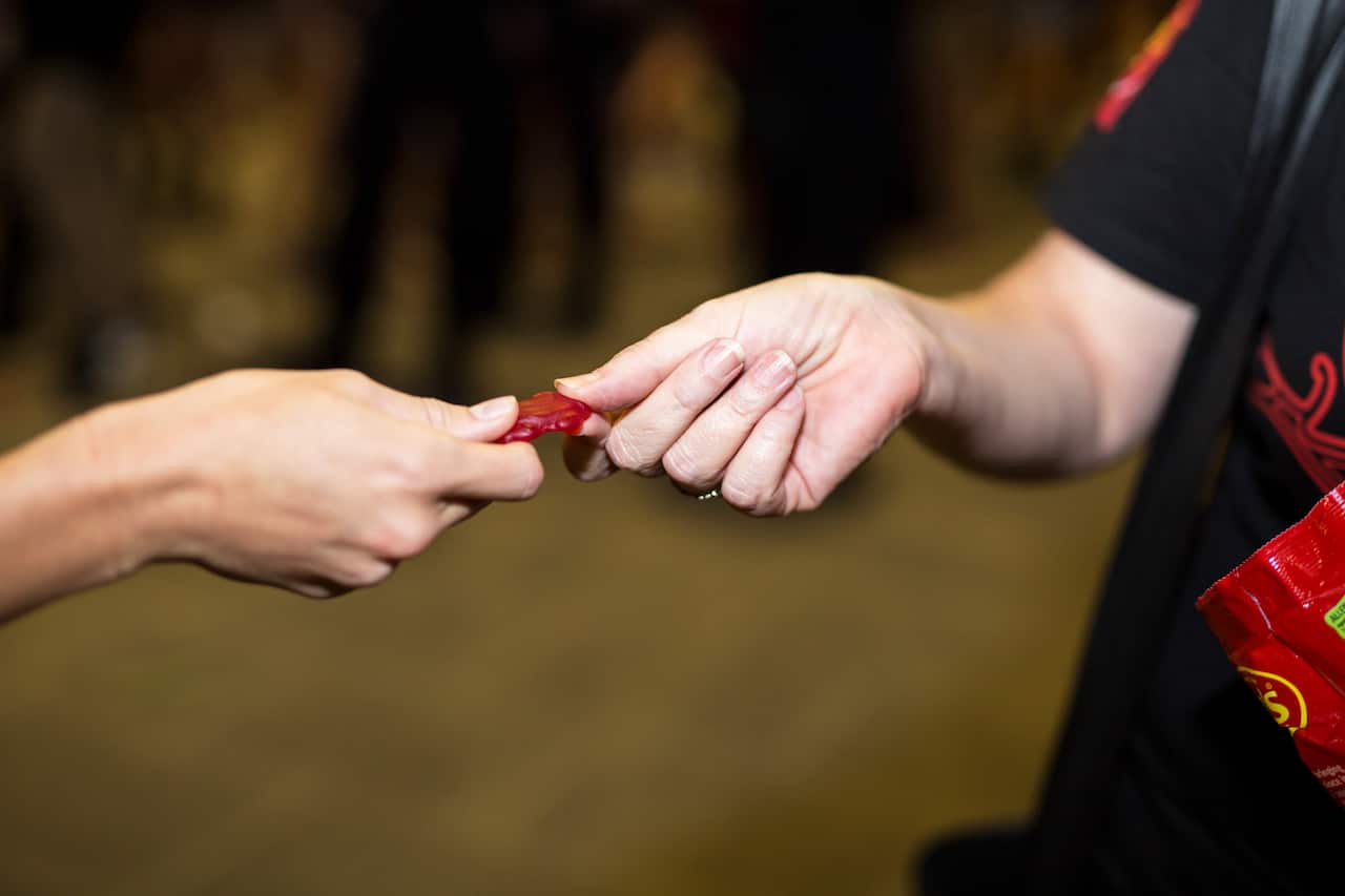 Red Frogs Australia volunteers handing out lollies at Schoolies.
