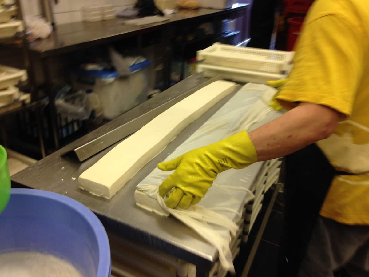 Removing todu from the moulds at Như Quỳnh tofu factory in Yagoona