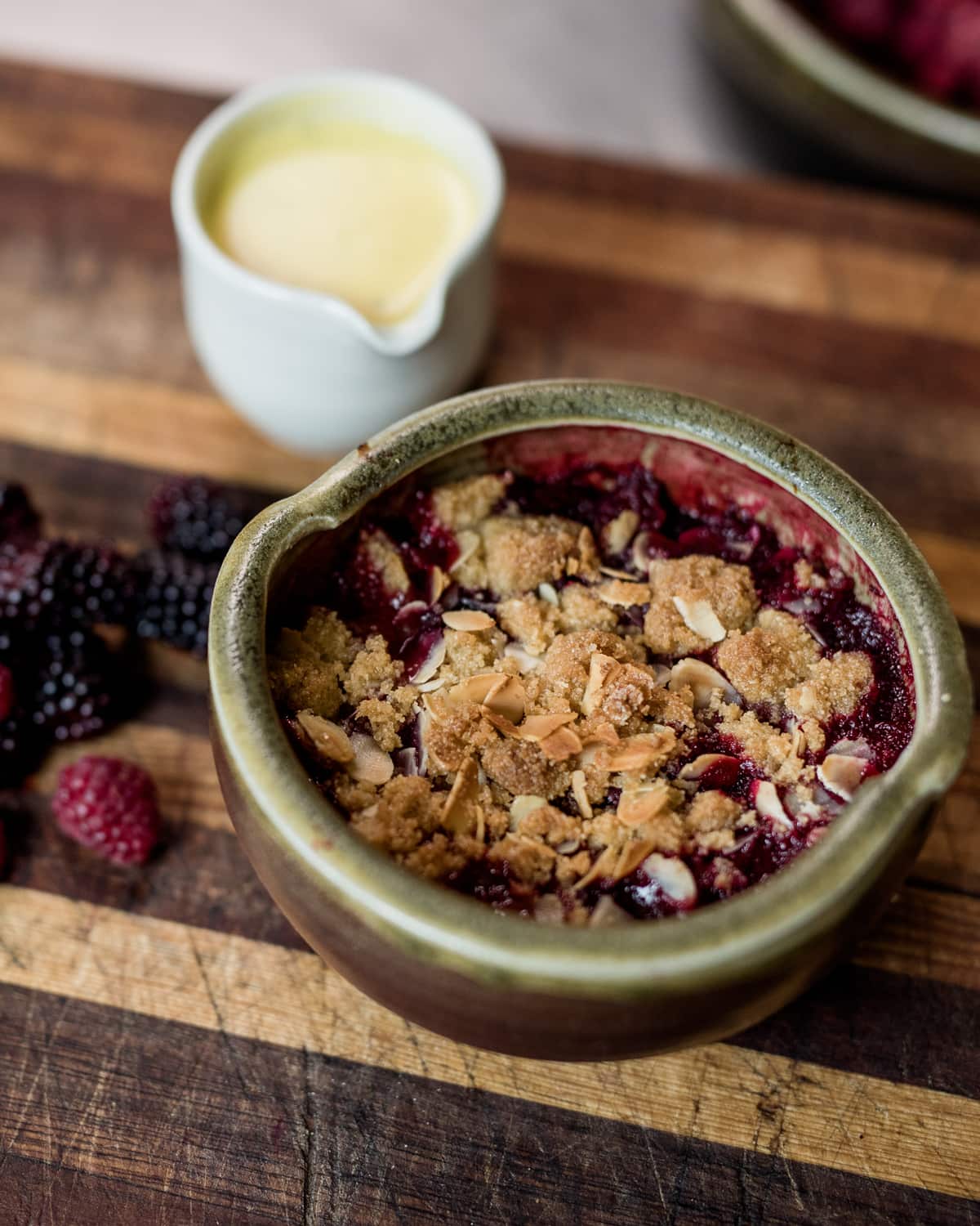 Rhubarb and berry crumble with goat's milk and vanilla custard